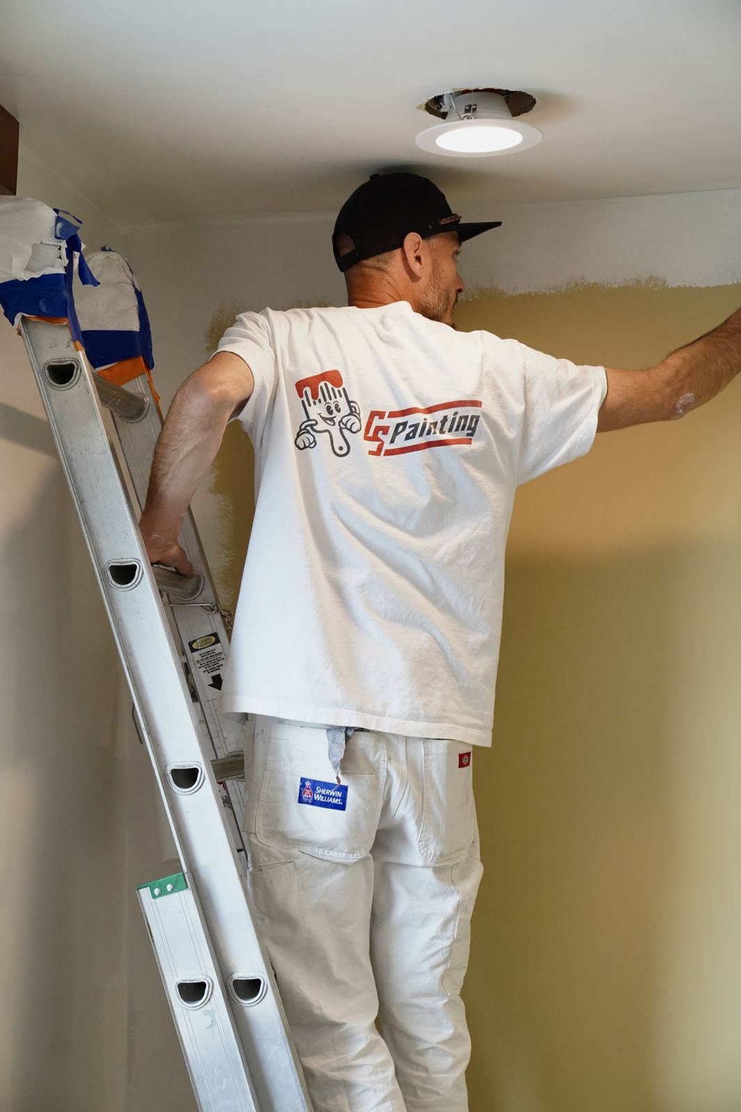 Cutting in a ceiling line by hand from a ladder