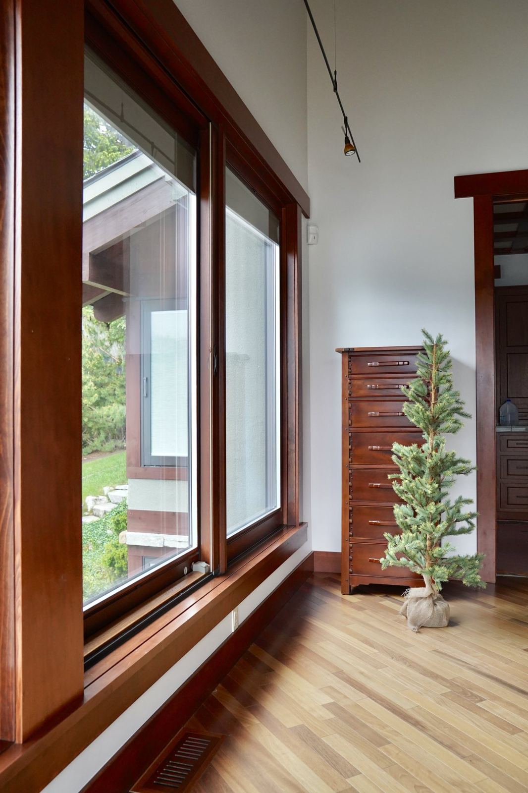 A finished room with clean walls and wood-trimmed windows